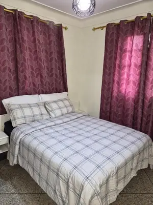 a bed in a room with purple curtains at Villa appartement jardin et piscine in Meknès