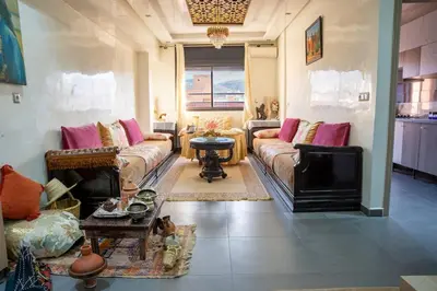 a living room with two couches and a tv at VIP Luxury Stay Béni Mellal in Beni Mellal