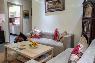 a living room with a couch and a table with a bowl of fruit at VIP Luxury Stay Béni Mellal in Beni Mellal