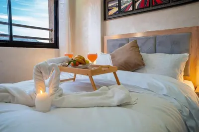a bed with a table with a candle and a tray of food at VIP Luxury Stay Béni Mellal in Beni Mellal