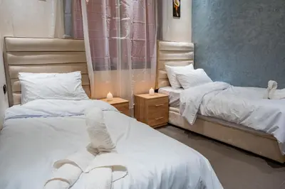 a bedroom with two beds with towels on them at VIP Luxury Stay Béni Mellal in Beni Mellal