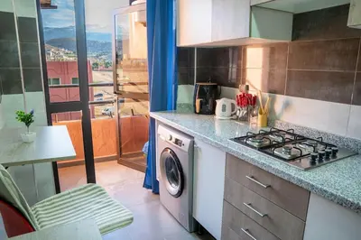 a kitchen with a stove and a washing machine at VIP Luxury Stay Béni Mellal in Beni Mellal