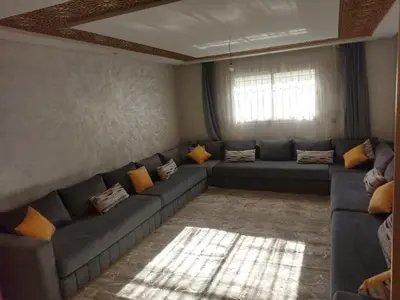 a living room with a couch and a window at Beautiful Apartment for Rent in Corniche de Rabat in Oulad Akkou
