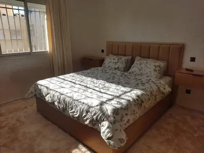 a bedroom with a bed and a window at Beautiful Apartment for Rent in Corniche de Rabat in Oulad Akkou