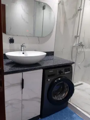 a bathroom with a washing machine and a sink at Beautiful Apartment for Rent in Corniche de Rabat in Oulad Akkou