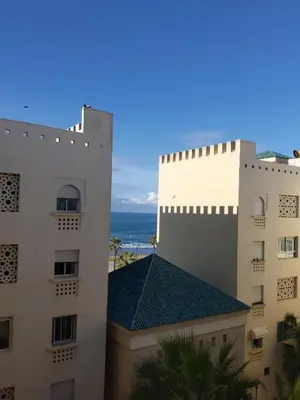 a view of two buildings and the ocean at Beautiful Apartment for Rent in Corniche de Rabat in Oulad Akkou