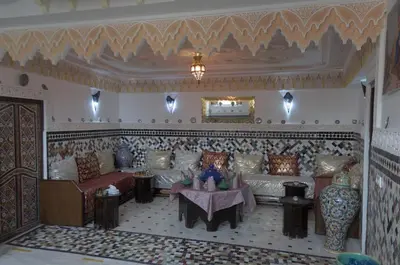 a living room with couches and a table in a room at Riad Dalal in Fès
