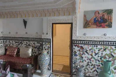 a room with a couch and a painting on the wall at Riad Dalal in Fès