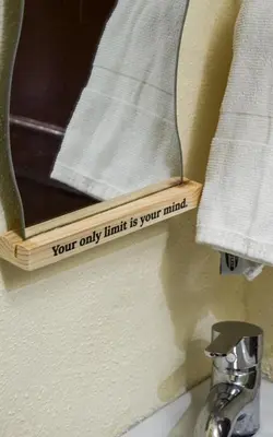 a mirror on a bathroom wall with towels at Dar sarah médina Fés in Fès
