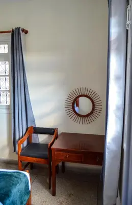 a room with a chair and a mirror on the wall at Dar sarah médina Fés in Fès