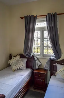 a bedroom with two beds and a window at Dar sarah médina Fés in Fès