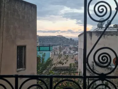 a view of a city from a balcony of a building at Dar sarah médina Fés in Fès