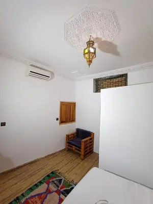 a room with a bed and a chandelier at Riad Slima Fes in Fès