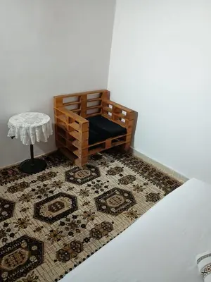a room with a bench and a table on a rug at Riad Slima Fes in Fès
