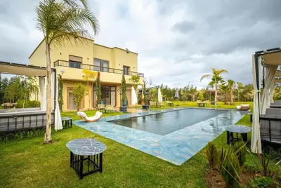 a swimming pool in the backyard of a house at Villa Hasard Marrakech in Had Abdallah Rhiat