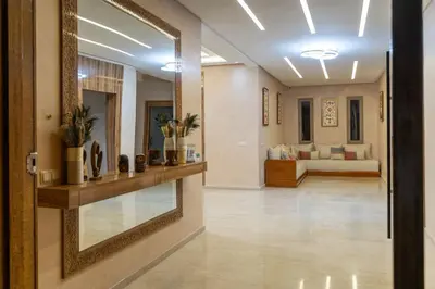 a hallway with a mirror and a living room at Villa Hasard Marrakech in Had Abdallah Rhiat
