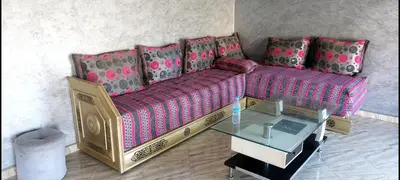 a living room with a couch and a table at Bright apartment with balcony in the center of FES in Fès