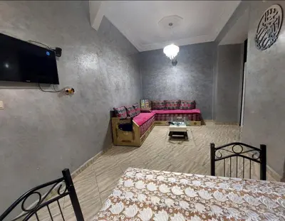 a living room with a couch and a tv at Bright apartment with balcony in the center of FES in Fès