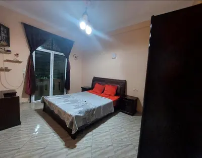 a bedroom with a bed with red pillows on it at Bright apartment with balcony in the center of FES in Fès