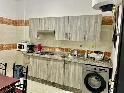 a kitchen with a sink and a washing machine at Chic apartment in Fes luxurious and family friendly in Oulad Akkou