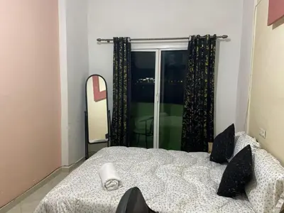 a bedroom with a bed and a large window at Chic apartment in Fes luxurious and family friendly in Oulad Akkou
