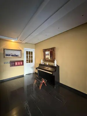 a room with a piano in the middle of a room at Welcome to your Stylish apartment in Oulad Akkou