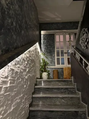 a staircase in a house with a window at Welcome to your Stylish apartment in Oulad Akkou