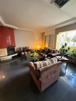 a large living room with couches and a table at Welcome to your Stylish apartment in Oulad Akkou