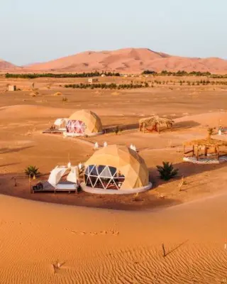 a desert with tents in the middle of the desert at Erg Chebbi Luxury Geodesic Camp in Merzouga