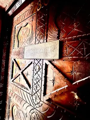 a wooden door with a sign that says required at Nid avec jacuzzi en centre ville in Oulad Akkou