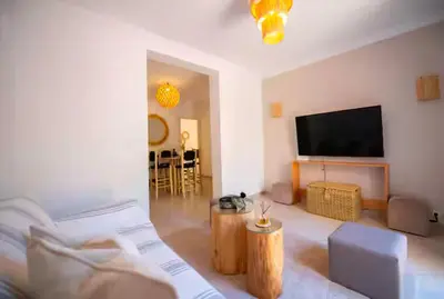 a living room with a flat screen tv on the wall at Modern Elegance & Moroccan Charm 5 min Hivernage in Oulad Akkou