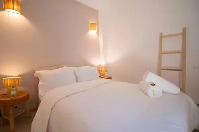 a bedroom with a white bed with a stuffed animal on it at Modern Elegance & Moroccan Charm 5 min Hivernage in Oulad Akkou