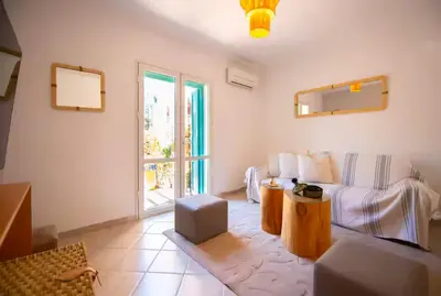 a living room with a couch and a window at Modern Elegance & Moroccan Charm 5 min Hivernage in Oulad Akkou