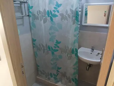 a bathroom with a shower curtain and a sink at مفتاح الساحل in Oulad Akkou