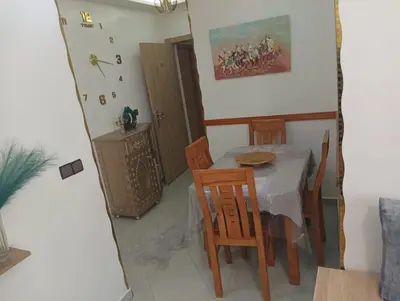 a dining room with a table and chairs in a room at مفتاح الساحل in Oulad Akkou