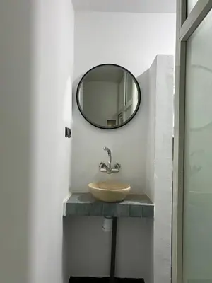 a bathroom with a sink and a mirror on the wall at Desert Getaway Apartment In Ouarzazate in Ouarzazate