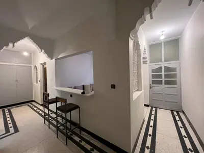 a hallway with a door and a staircase in a house at Desert Getaway Apartment In Ouarzazate in Ouarzazate
