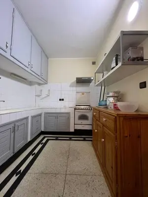 a kitchen with white cabinets and a stove at Desert Getaway Apartment In Ouarzazate in Ouarzazate