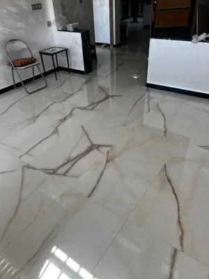 a white marble floor in a room with a table at Dar rahma in Khenifra