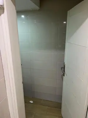 a bathroom with a white shower stall with a door at Dar rahma in Khenifra