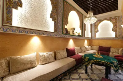 a living room with a couch and a table at Dar Laabi - Riad Aya in Fès