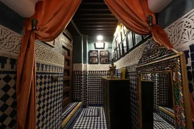 a room with a shower with a bed and a curtain at Dar Laabi - Riad Aya in Fès