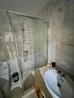 a bathroom with a shower and a sink and a toilet at Appartement à louer à BOUZNIKA OUED CHERRAT in Oulad Akkou