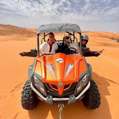 two people in a vehicle in the desert at Golden Silence Camp in Merzouga