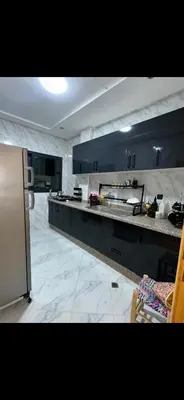 a kitchen with black cabinets and a counter top at Shahd in Meknès