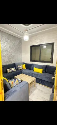 a living room with a blue couch and a table at Shahd in Meknès