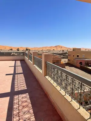 a balcony with a view of the desert at Maison El Alia in Merzouga