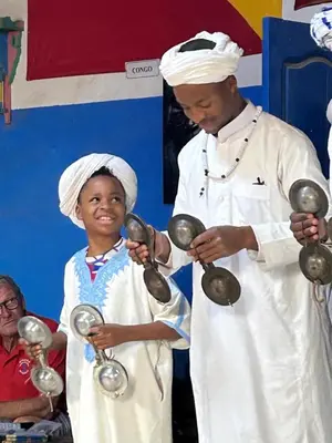 a man and a little boy holding magnifying glass at Maison El Alia in Merzouga
