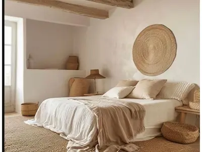 a bedroom with a white bed with a largereath on the wall at Riad Sibaya fes in Fès