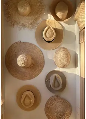 a display of straw hats on a wall at Riad Sibaya fes in Fès